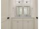 Bathroom featuring double sinks, marble countertop, and clean white finishes, creating a bright and luxurious space at 201 S Ennis St, Fuquay Varina, NC 27526