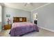 Bedroom with wooden headboard, lavender bedding, and an ensuite bathroom, offering comfort and convenience at 201 S Ennis St, Fuquay Varina, NC 27526