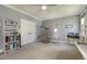 Spacious bedroom features a comfortable chair, TV, and ample storage, creating a cozy and organized living space at 201 S Ennis St, Fuquay Varina, NC 27526