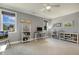 Bedroom featuring neutral gray walls, a ceiling fan, and windows for a bright and comfortable atmosphere for work or relaxation at 201 S Ennis St, Fuquay Varina, NC 27526
