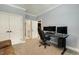 Bedroom setup with a desk and a gaming chair, featuring comfortable carpet and neutral walls, perfect for focus and leisure at 201 S Ennis St, Fuquay Varina, NC 27526