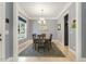 Light-filled dining room with elegant chandelier, neutral walls, and classic hardwood floors at 201 S Ennis St, Fuquay Varina, NC 27526