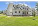 Expansive home features a connected garage, a well-kept lawn, and meticulous landscaping at 201 S Ennis St, Fuquay Varina, NC 27526