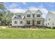 Beautiful two-story home boasts a well-manicured front lawn and a charming, covered front porch at 201 S Ennis St, Fuquay Varina, NC 27526