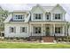 Inviting two-story home showcasing a classic facade, landscaped lawn, and brick-lined front porch at 201 S Ennis St, Fuquay Varina, NC 27526