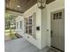 Charming front porch with wood ceiling features stylish lighting and classic architectural details at 201 S Ennis St, Fuquay Varina, NC 27526