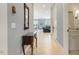 Bright hallway featuring hardwood floors, a wooden console table, and views into the living area at 201 S Ennis St, Fuquay Varina, NC 27526