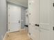 Hallway with hardwood floors and a built-in bench with storage, and a coat rack at 201 S Ennis St, Fuquay Varina, NC 27526