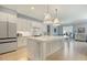 Bright, open kitchen with a large center island, stainless steel appliances, and modern fixtures at 201 S Ennis St, Fuquay Varina, NC 27526