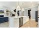 Open kitchen with a large island, stainless steel appliances, and hardwood floors at 201 S Ennis St, Fuquay Varina, NC 27526