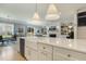 Bright and airy kitchen with a large island, stainless steel appliances, and a view into the living room at 201 S Ennis St, Fuquay Varina, NC 27526
