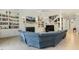 Bright living room with built-in bookcases, fireplace, and a plush blue sectional sofa at 201 S Ennis St, Fuquay Varina, NC 27526