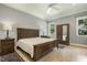 Bedroom with a large bed, ceiling fan, wooden furniture set, and natural light from windows at 201 S Ennis St, Fuquay Varina, NC 27526