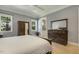 Bright main bedroom showcasing a wooden dresser and wardrobe plus large windows that bring in lots of natural light at 201 S Ennis St, Fuquay Varina, NC 27526