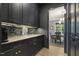 Well-organized pantry with dark wood cabinets, granite countertops, and modern backsplash at 201 S Ennis St, Fuquay Varina, NC 27526