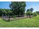 Community dog park offers fenced area for dogs to play in a natural setting with mature trees at 2027 Hayes Ln, Holly Springs, NC 27540