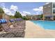 Community pool with ample lounge seating and sunbathing area available for residents to enjoy at 2027 Hayes Ln, Holly Springs, NC 27540