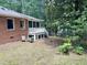 Backyard featuring a screened porch, landscaped yard, and a view of the water at 207 Wood Cir, Chapel Hill, NC 27514