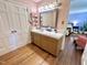 Charming bathroom featuring classic vanity, a mirror, and a peek into the bright adjoining bedroom at 207 Wood Cir, Chapel Hill, NC 27514
