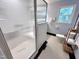 Bright bathroom with shower and patterned glass door, blue walls and tile flooring at 207 Wood Cir, Chapel Hill, NC 27514