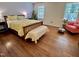 Sunny bedroom with hardwood floors, large windows, and a comfortable bed topped with bright floral bedding at 207 Wood Cir, Chapel Hill, NC 27514