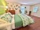 Lively bedroom with unique wall decor, hardwood floors, and a bed featuring a refreshing green floral duvet cover at 207 Wood Cir, Chapel Hill, NC 27514