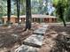 Charming brick home with blue door and lush surrounding greenery at 207 Wood Cir, Chapel Hill, NC 27514