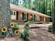 Ranch-style home featuring unique flower decorations, brick facade, and accessible ramp at 207 Wood Cir, Chapel Hill, NC 27514