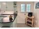 Eat-in kitchen features black countertops and a cozy coffee bar area near a window at 207 Wood Cir, Chapel Hill, NC 27514
