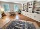 Bright living room features hardwood floors, built-in bookshelves, and large windows at 207 Wood Cir, Chapel Hill, NC 27514