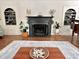 Warm living room featuring a fireplace, piano, and stylish built-in shelving at 207 Wood Cir, Chapel Hill, NC 27514