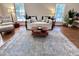 Bright living room with a decorative rug, daybed, and abundant natural light at 207 Wood Cir, Chapel Hill, NC 27514