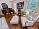 Comfortable living room seating area with patterned chair and piano at 207 Wood Cir, Chapel Hill, NC 27514