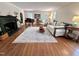 Cozy living room featuring fireplace, hardwood floors, piano, and natural light at 207 Wood Cir, Chapel Hill, NC 27514