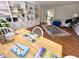 Open concept living room with hardwood floors, built-in bookshelves, and dining area at 207 Wood Cir, Chapel Hill, NC 27514