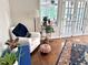 Sitting area features a comfy chair, hardwood floors, and bright light from adjacent room at 207 Wood Cir, Chapel Hill, NC 27514