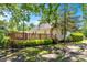 Exterior view of a home with a wooden deck overlooking a landscaped yard at 209 E Church St, Creedmoor, NC 27522