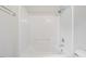 Bright bathroom with tub and shower combo, featuring neutral tones at 209 E Church St, Creedmoor, NC 27522