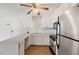 Bright kitchen featuring white cabinets and stainless steel appliances at 209 E Church St, Creedmoor, NC 27522