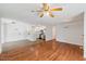 Open-concept living space with hardwood floors leading to the kitchen at 209 E Church St, Creedmoor, NC 27522