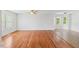 Sunlit living room with hardwood floors and large windows at 209 E Church St, Creedmoor, NC 27522