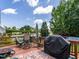 Spacious back deck featuring an outdoor dining table, patio chairs, and a BBQ grill for entertainment at 229 Hocutt Farm Dr, Clayton, NC 27527