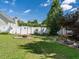 Expansive backyard featuring a fire pit, a wooden swing, a well-manicured lawn, and a privacy fence at 229 Hocutt Farm Dr, Clayton, NC 27527