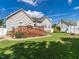 Spacious backyard featuring a large wooden deck, manicured lawn, and beautiful landscaping for outdoor enjoyment at 229 Hocutt Farm Dr, Clayton, NC 27527
