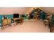 Finished bonus room showcasing sloped ceilings, a desk area, and custom shelving for organized storage at 229 Hocutt Farm Dr, Clayton, NC 27527