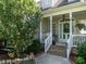 Welcoming front porch with decorative columns and a cozy seating area at 229 Hocutt Farm Dr, Clayton, NC 27527
