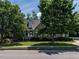 Inviting brick home featuring manicured landscaping and mature shade trees at 229 Hocutt Farm Dr, Clayton, NC 27527