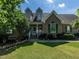 Charming brick home with lush green lawn, dormer windows, and manicured landscaping at 229 Hocutt Farm Dr, Clayton, NC 27527