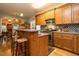 Functional kitchen with oak cabinets, breakfast bar, and stainless steel appliances at 229 Hocutt Farm Dr, Clayton, NC 27527