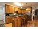 Practical kitchen featuring oak cabinets, breakfast bar, and stainless steel appliances at 229 Hocutt Farm Dr, Clayton, NC 27527